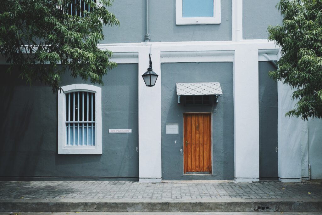 front of grey and white condo building