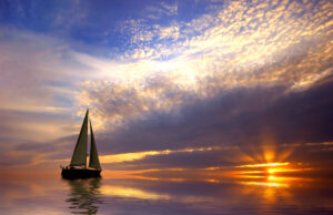 SailBoat on calm water with sunset